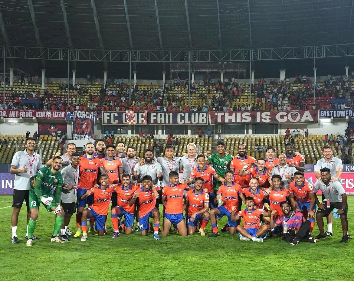 FC Goa players and coaching staff celebrating together on the pitch in front of the club's fans