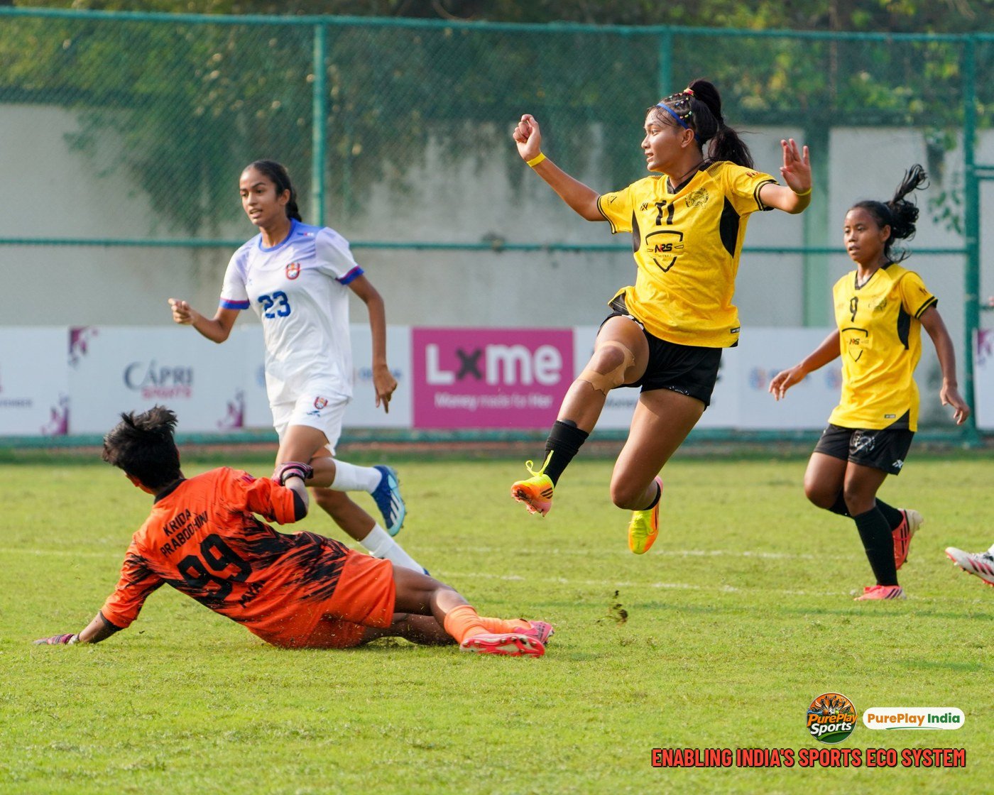 Alva of YWC, Manipur gets a shot away past the diving Pune Krida Prabhodhini Academy goalkeeper