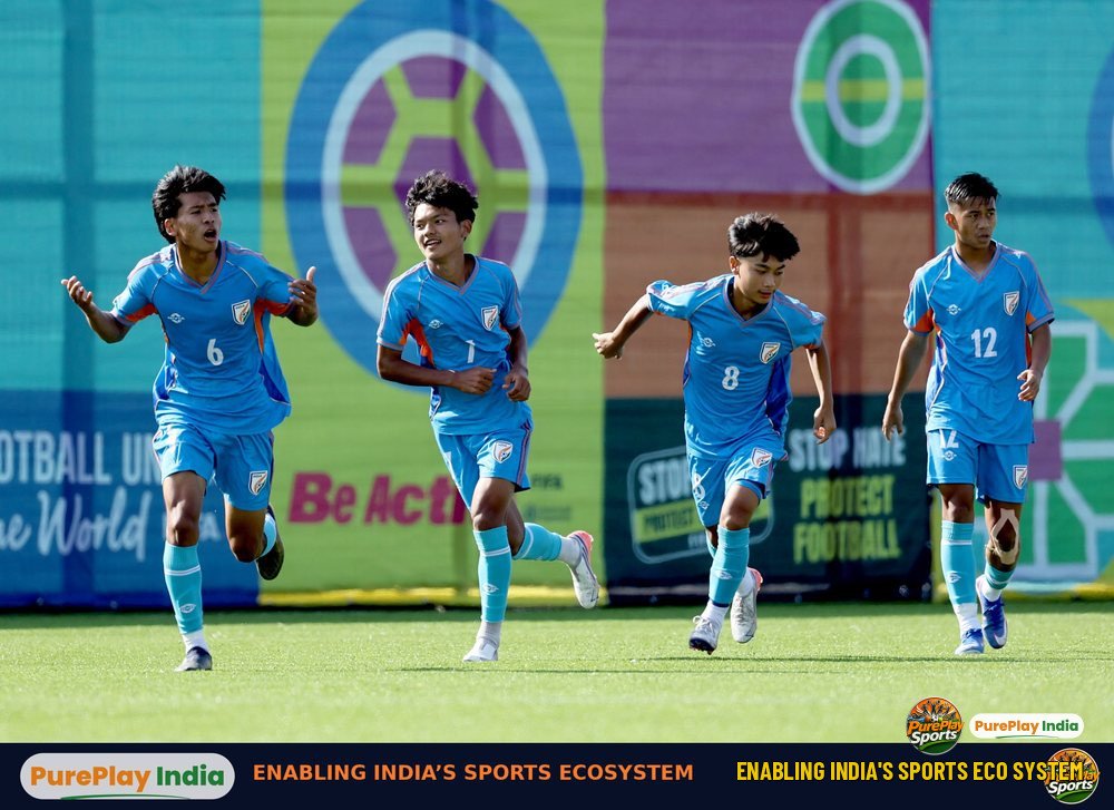 Four India U15 players in sky blue shirts run on the pitch in Baku during the FIFA U15 World Cup and Festival