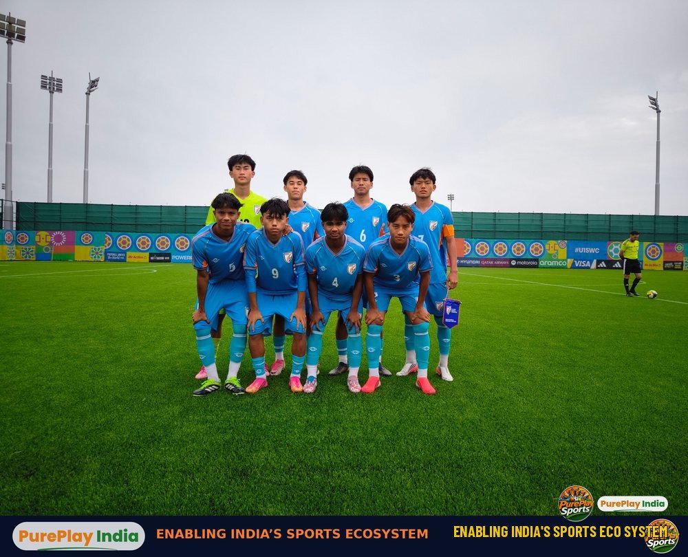 India U15 players in sky blue shirts line up for a team photo on a grass pitch in Baku at the FIFA U15 World Cup and Festival