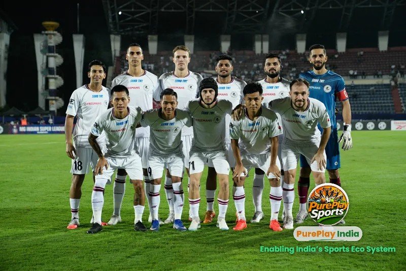 Mohun Bagan Super Giant players in white line up for a team photo before their MG ISL match against NorthEast United FC