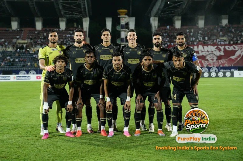 NorthEast United FC players in black line up for a team photo before their MG ISL match against Mohun Bagan Super Giant